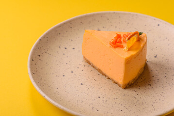 A slice of yellow cheesecake cake flavored with lemon and passion fruit