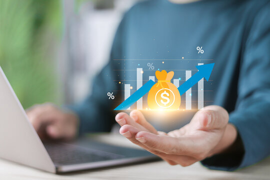 Revenue increase concept, Income increase, high return on investment, revenue growth, interest rate, compound interest and added value. Person holding increased profit chart on virtual screen.