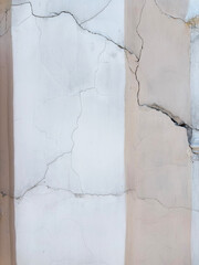 beige old wall with cracks and vertical white stripe