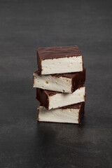 Bird's milk. Delicate dessert. Vanilla souffle in chocolate glaze. Dark background