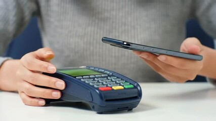 Contactless payment with smartphone at POS terminal - Powered by Adobe
