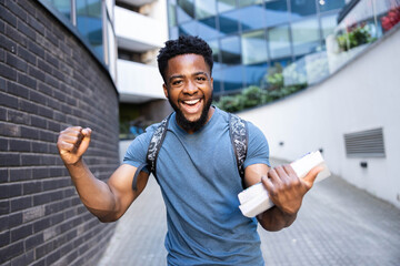 A young student celebrates success with raised fists, embodying excitement and achievement in an...