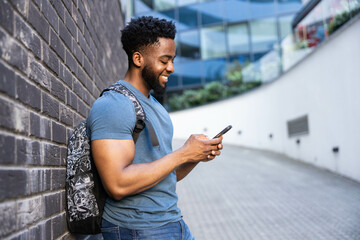 A smiling student enjoys using their smartphone, showcasing engagement and connectivity in a...