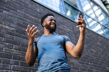 An enthusiastic young man animatedly discussing on his phone, portraying energy and connectivity...