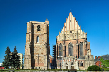 medieval campanile and facade of a gothic church in the city of Nysa