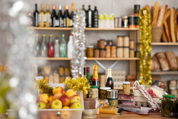 Different products on counter in grocery store decorated for new year..
