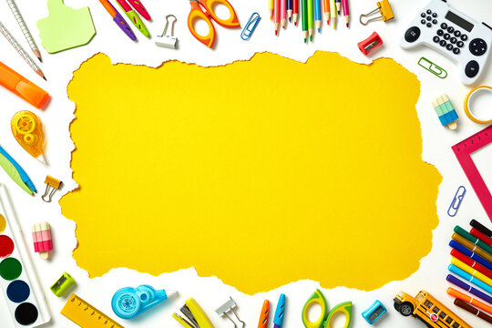 Frame border made of colorful school and art supplies on white background with yellow center. Back to school, education concept.