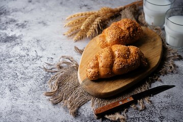 Sesame seeds braided bun on a grey background