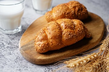 Sesame seeds braided bun on a grey background