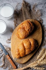 Sesame seeds braided bun on a grey background