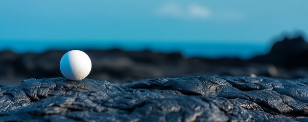 White Sphere on Black Lava Rock with Blue Sky, Abstract, Minimalist