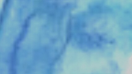 A blurry image featuring a blend of light blue and teal shades, creating a soft, abstract watercolor effect. The colors transition smoothly, lacking sharp lines or defined shapes.