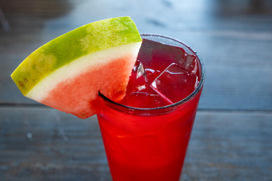 Refreshing watermelon cocktail with slice of watermelon garnish