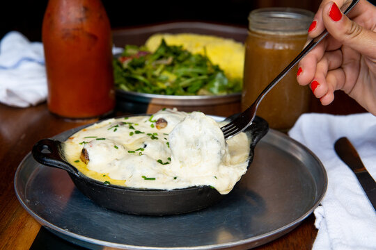 Pizza dough balls covered with gravy and cheese	