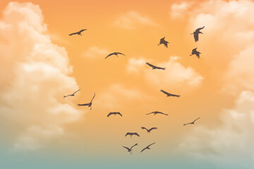 Sunset sky with birds flying and fluffy orange clouds in the background