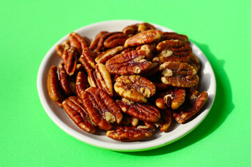 Delicious salted pecan nuts scattered.