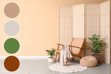 Interior of living room with wooden armchair, folding screen and plants