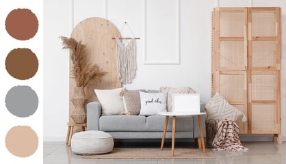 Interior of light living room with grey sofa and wooden folding screen. Different color patterns