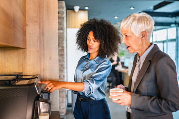 African american woman talk with colleague use modern coffee machine