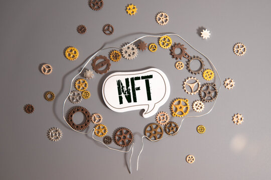 NFT text on torn paper.