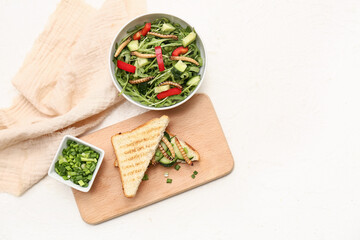 Naklejka premium Sandwich with fried maggots and bowl of fresh salad on white background