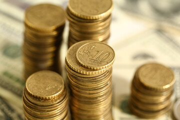 Golden coins with dollars as background