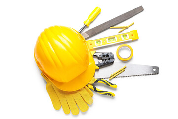 Hardhat, gloves and construction tools on white background