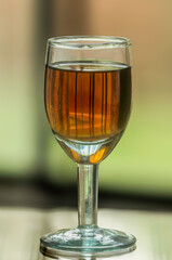Glass of red wine on the table with bokeh background