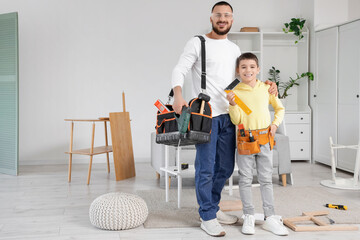 Father with assembly tools and his son at home