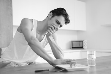 Young man with anorexia refusing from food in kitchen