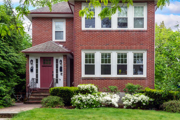 Charming two-story family home surrounded by spring greenery in Newton, Massachusetts, USA