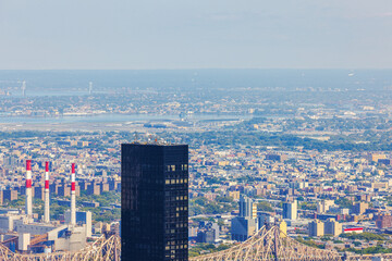 Fototapeta premium Distant view of New York City skyscrapers, power plant and Verrazzano Bridge in smog. New York. USA. 