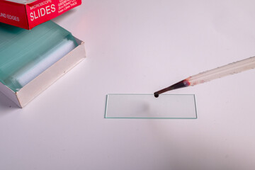 Blood sample dropped on glass slide for microscopic analysis
