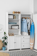 Interior of light room with surfboard and closet