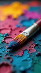 Obraz premium Close-up of a paintbrush resting on a vibrant artist's palette, ready for the next stroke of creative genius Oil paints, textures, and colors are richly displayed , brushstrokes, vibrant