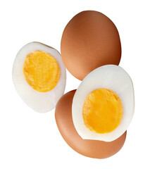 Top view of two raw chicken eggs and peeled cooked or boiled egg with egg yolk in two halves in stack isolated on white background with clipping path