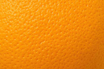 Macro close-up of orange peel showing vibrant color and natural dimpled surface texture