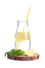 Wooden board with bottle of fresh lemonade on white background