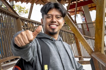 Happy latino man giving thumbs up