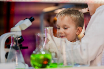 A young scientist and a child conducting an experiment in a laboratory. Encouraging curiosity, STEM...