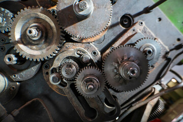 A close-up of industrial metal gears showcases precision engineering and mechanical design. The intricate machinery parts highlight the complexity of industrial manufacturing processes and technology.