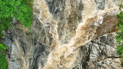 A flooded river rushing through dense rainforest, highlighting vibrant ecosystems where carbon capture, oxygen production, and biodiversity support climate resilience and sustainability. Thailand.
