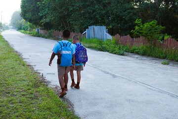 A fun and determined walk to school for older and younger siblings.