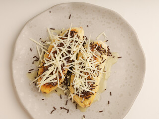Toasted banana with cheese and chocolate sprinkle on a plate