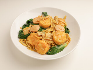 Fried noodle with tofu on white plate