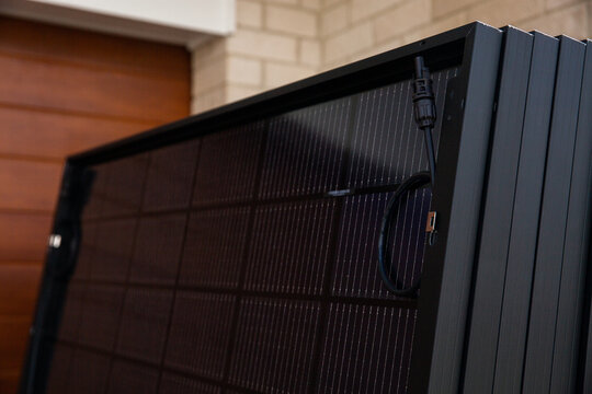 a stack of solar panels ready to go on a roof