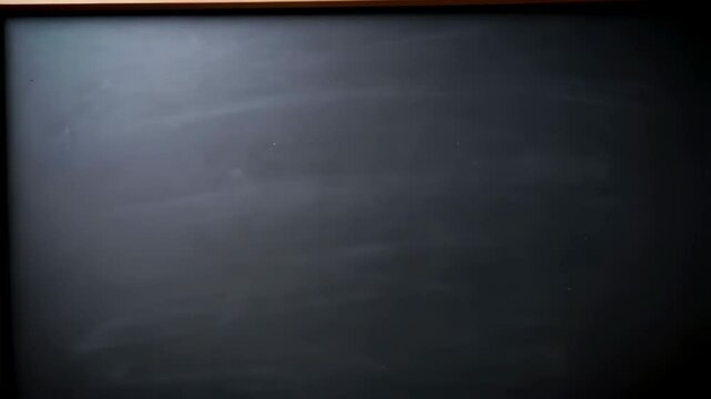 Empty chalkboard with light wood frame. Dark slate surface for writing messages, drawing, teaching, or creative design concepts.