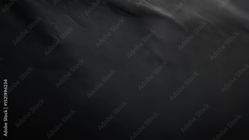Poster abstract shot showing smooth black material with a slightly reflective sheen; suitable for backgroun
