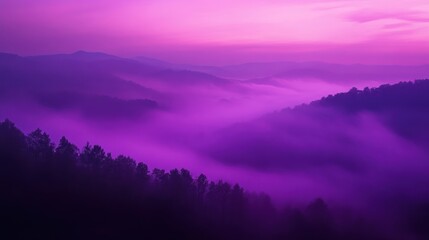 Purple sunrise over misty mountain range.