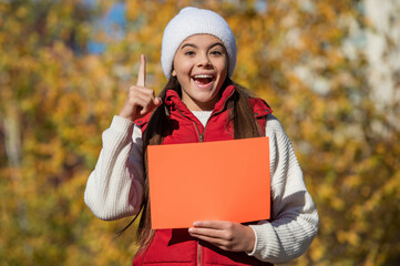 autumn offer. fall season sale. seasonal discount for school. fall girl promoter. autumn girl promoter hold paper with copy space. teen girl promoting advertisement. inspired with idea
